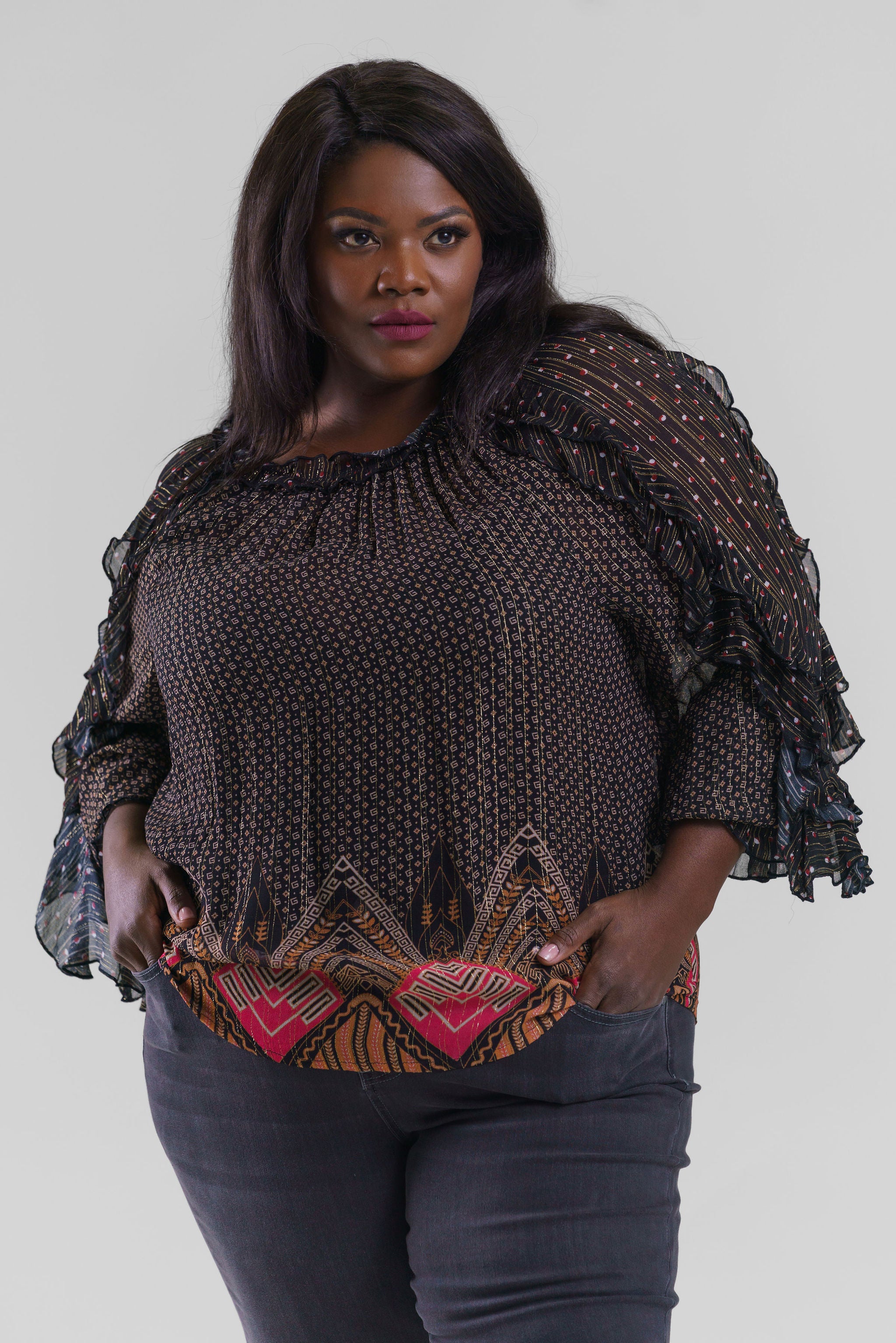 Plus size, gathered neck, long sleeves with a ruffle detail throughout the length