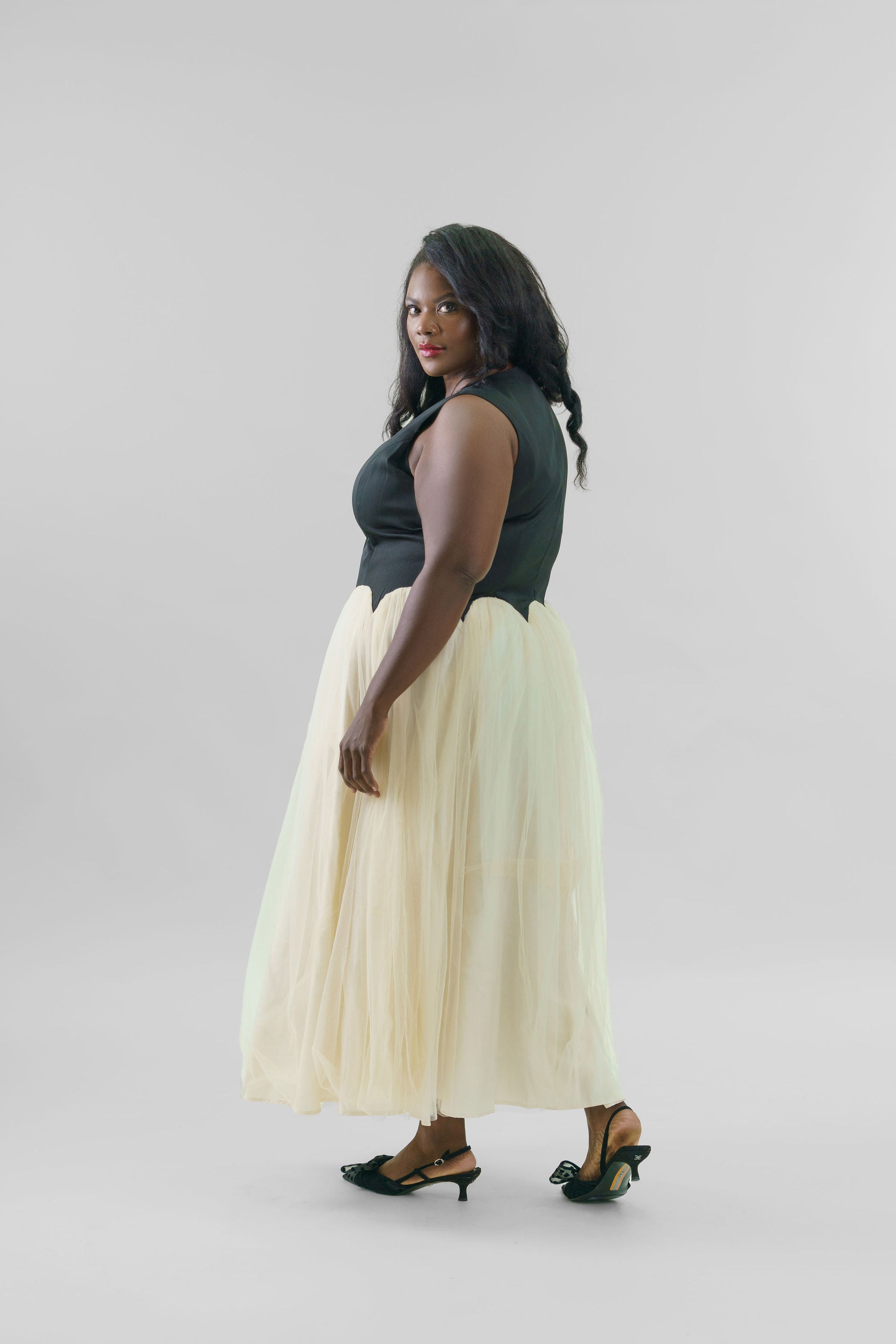 black and cream dress accessories This black-and-cream dress is proof that simple can still make a statement. Add gold accessories and a structured handbag, and you're ready for work, dinner, or any special event., Shop the look